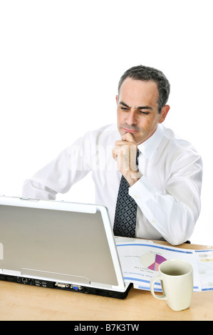 Thoughtful businessman sitting at his desk isolated on white background Stock Photo