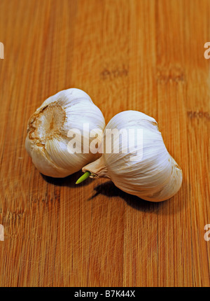 Garlic Bulbs on Wooden Cutting Board Stock Photo - Alamy