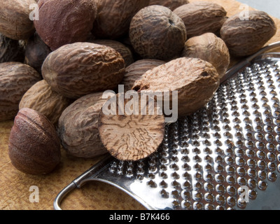 close-up of nutmegs and metal grater Stock Photo