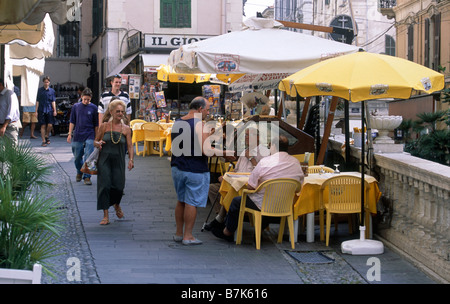 Street Cafe Old town People seated walking SAN REMO LIGURIA ITALY Stock Photo