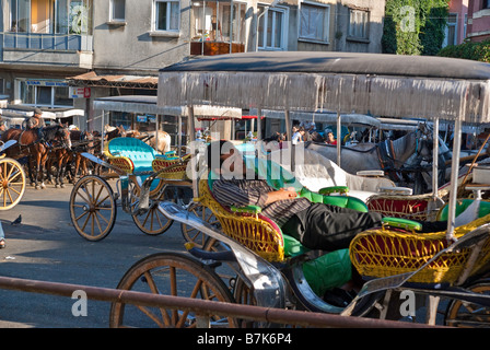 Cabbies resting in carriages while waiting for fares . Stock Photo