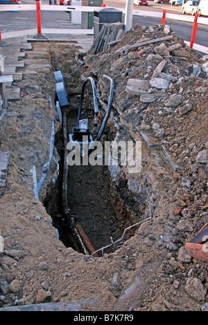 Road works Hole in pavement, dug for access to telecommunications ...