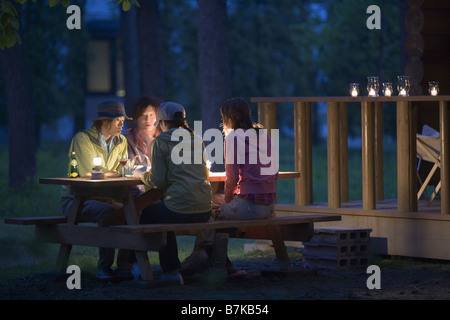 Group of Young People are Chatting on Campsite at Early Night Stock Photo