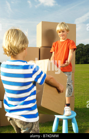 boy handing box to his brother Stock Photo