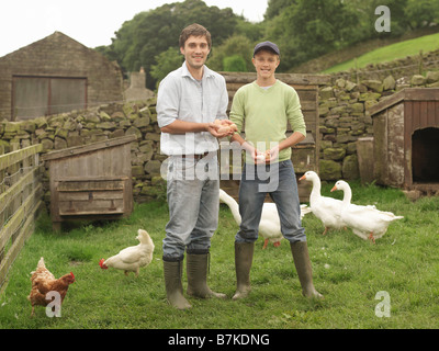 Farmer And Boy Holding Eggs