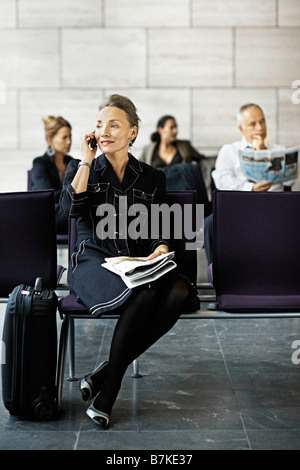 Woman with a suitcase, on the phone Stock Photo