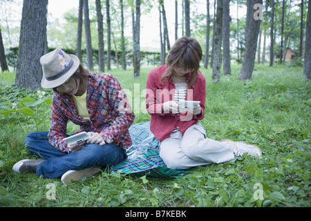Young Couple Playing Portable Video Game Stock Photo