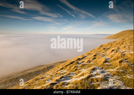 Winter view over Upper Eden valley from Tailbrigg with the valley covered in mist Grass in foreground covered in Hoar frost Stock Photo