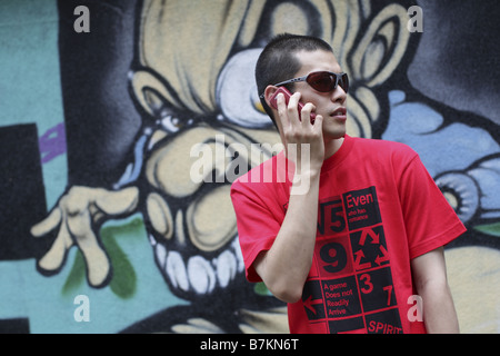 Man in Sunglasses Talking on Cell-phone Stock Photo