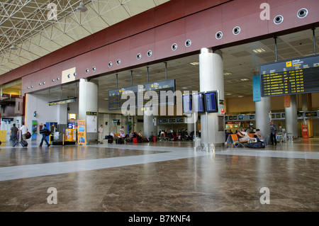 Airport terminal airline arrival and departures board travellers Reina Sofia Airport in southern Tenerife Canary Islands Stock Photo