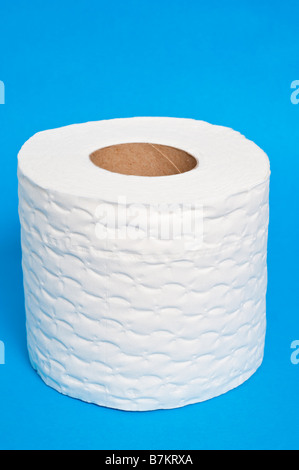 A close up of a white toilet roll  on a blue background Stock Photo