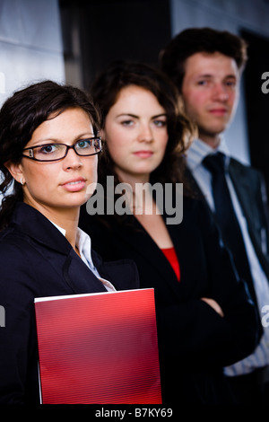 Portrait of successful happy business team posing at office lobby in front of elevator Dark background Stock Photo