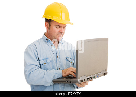 Construction engineer using his laptop computer on the job Isolated on white Stock Photo