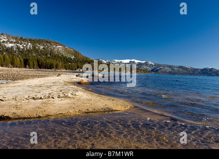 Sand and rocks line Kings Beach State Recreation Area Lake Tahoe California Stock Photo