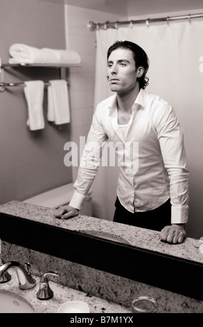 Young man looking at a mirror Stock Photo