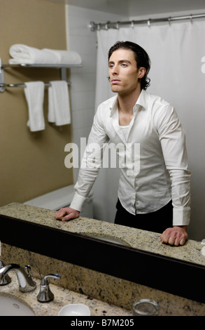 Young man looking at a mirror Stock Photo