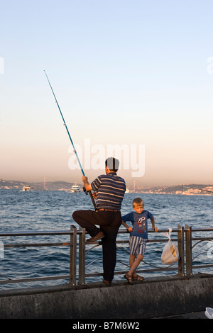 Fisherman on quayside at Eminönü Istanbul Turkey Stock Photo