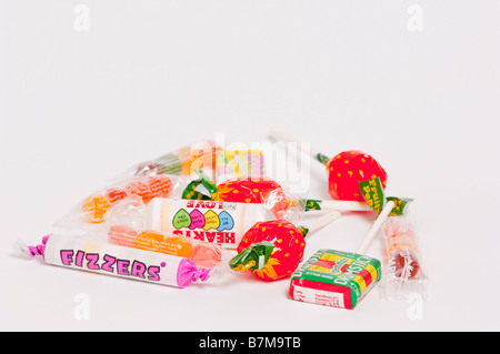 A close up of some candy sweets and lollipops on a white background Stock Photo