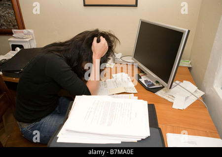 woman expressing frustration while working at desk in home office Stock Photo