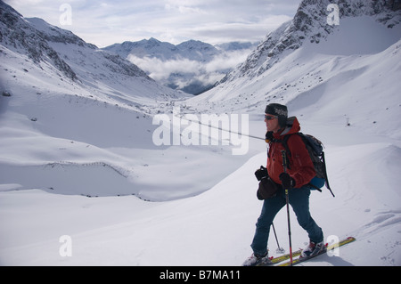 Ski alpinist above the snow covered Julier pass near the highest point. Swiss Alps, Graubunden. Stock Photo