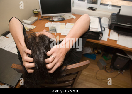 woman expressing frustration while working at desk in home office Stock Photo