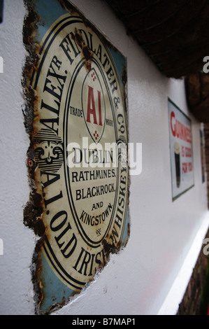 Old, weathered sign advertising Guinness on the wall of the Duke of York pub, Belfast. Stock Photo