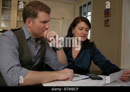 A couple looks over their finances together. Stock Photo