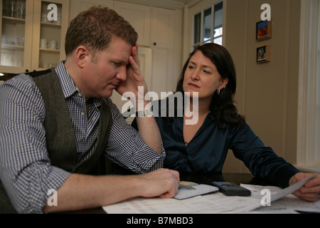 A couple looks over their finances together. Stock Photo