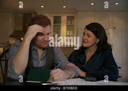 A couple looks over their finances together. Stock Photo