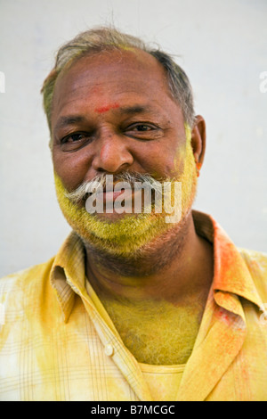 A man with yellow powder in his face during the Holi festival Stock Photo