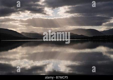 Sunrays and backlit clouds over Loch Tulla Rannoch Moor Scottish Highlands UK Stock Photo