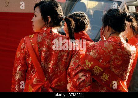 Paris France, Group Chinese Women, from behind, in Traditional Fancy Dress Parading in 'Chinese new year' in Street, From Rear, red chinese silk, Stock Photo