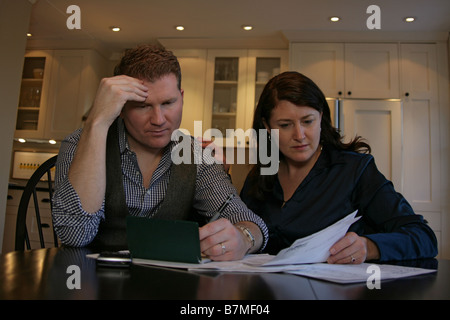 A couple looks over their finances together. Stock Photo