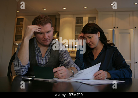 A couple looks over their finances together. Stock Photo