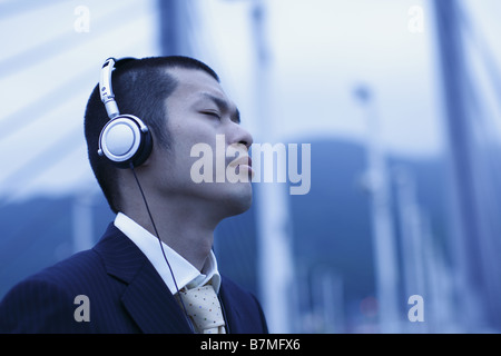 Businessman Listening to Music Stock Photo