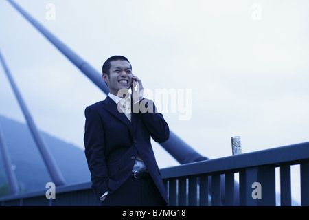 Smiling Businessman on Cell-Phone Stock Photo