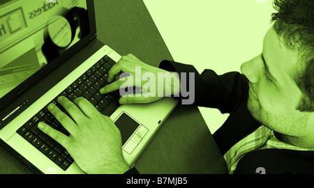 Businessman working at laptop isolated on yellow Stock Photo