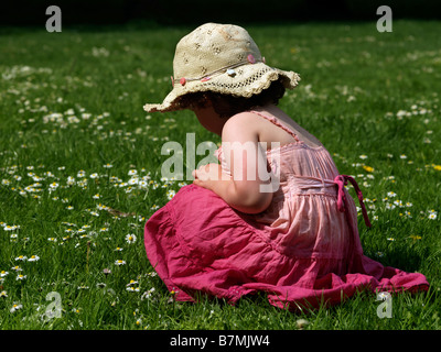 Four Year Old Girl Picking Daisies Stock Photo