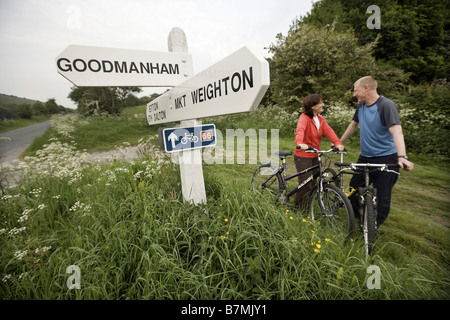 Couple cycling route 66 near Market Weighton The Wolds East Yorkshire UK Stock Photo