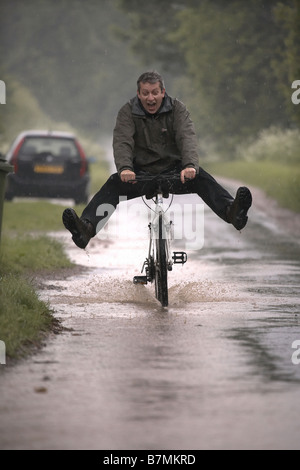 3rd June 2008 Cyclist in the heavy rain near Hull East Yorkshire Stock Photo