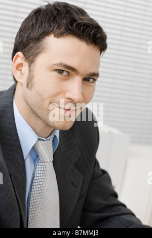 Portrait of happy smiling young businessman at office Stock Photo