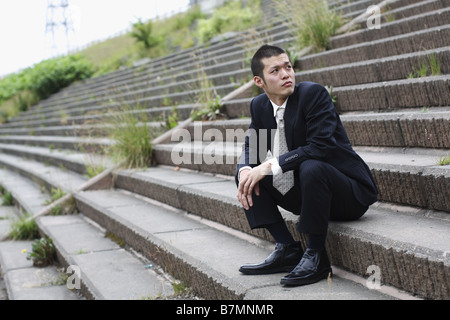 Businessman Sitting on Steps Stock Photo