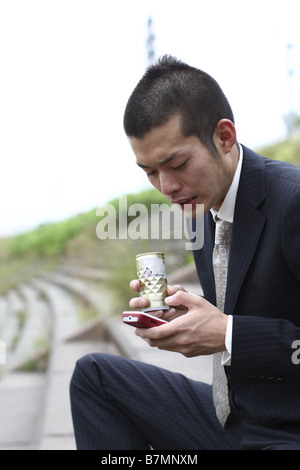 Businessman Holding and Dialing a Cell Phone Stock Photo