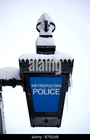 snow covered blue lamp of metropolitan police station at twickenham, middlesex, england Stock Photo