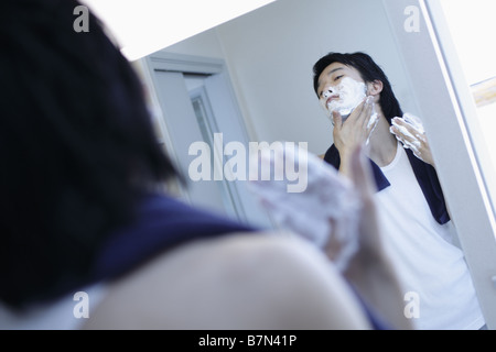 Man Shaving in a Bathroom Stock Photo