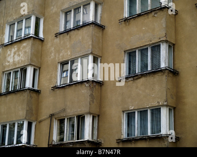Windows on a communist-bloc apartment building in Warsaw, Poland. Stock Photo