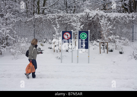 A shopper trudges across a Sainsbury's car park after unusually heavy snow fall in South London. Stock Photo