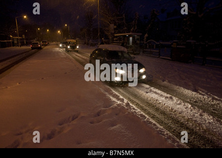 Motorists drive gingerly along Denmark Hill in South London after unusually heavy snowfalls Stock Photo