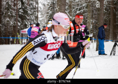 German coach Jochen Behle encouraging Evi Sachenbacher Stehle in classic cross-country ski race, Otepää, Estonia Stock Photo