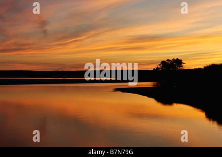 Sunrise Reflected on Au Train River where it Flows into Au Train Bay on Lake Superior Michigan Stock Photo